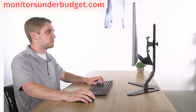 man sitting in front of monitor on table